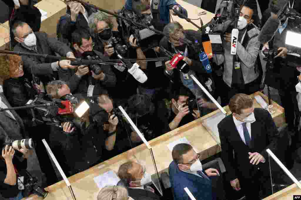 Sebastian Kurz, bottom right, leader of Austria&#39;s People&#39;s party and the party&#39;s parliamentary group leader, who recently resigned as Austrian Chancellor over a media corruption scandal, arrives to attend the parliamentary session at the Austrian Parliament in Vienna, Austria.