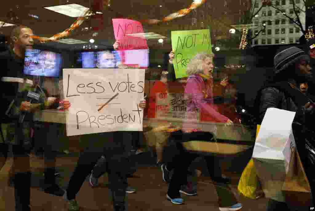 Protesters march in front of Trump Tower in downtown Chicago as they protest the election of President-elect Donald Trump, Nov. 10, 2016.