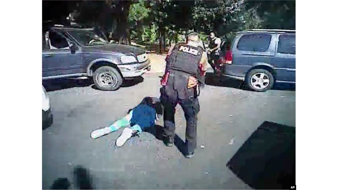 This image made from video provided by the Charlotte-Mecklenburg Police Department, Sept. 24, 2016, shows Keith Scott on the ground as police approach him in Charlotte, N.C., on Sept. 20, 2016.