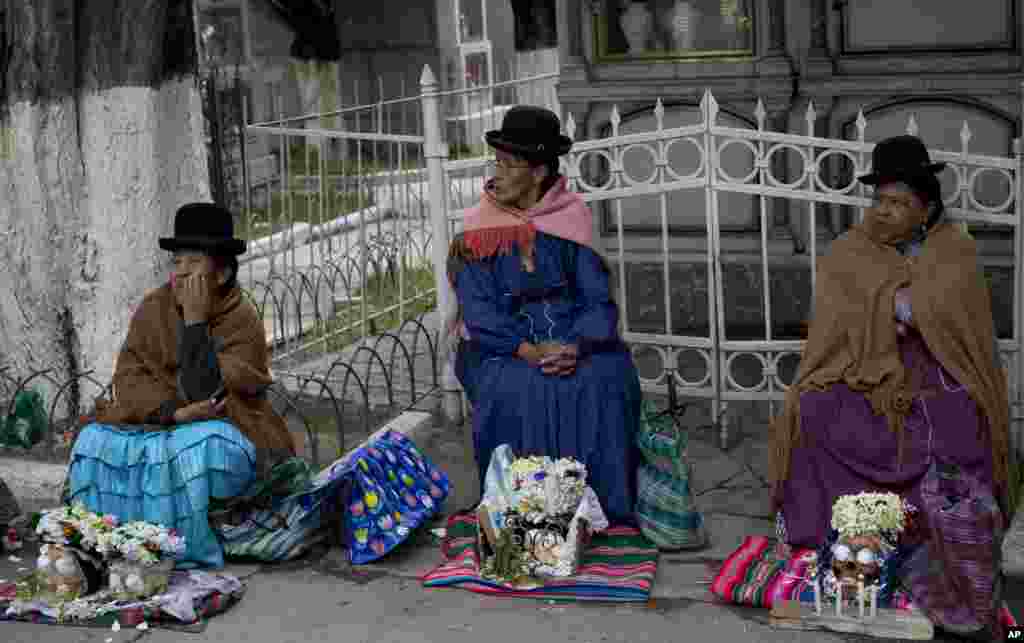 Women sit with their decorated human skulls at the at the General Cemetery during the Natitas Festival, in La Paz, Bolivia. Celebrated a week after the Day of the Dead, Bolivians carry human skulls adorned with flowers to cemeteries asking for money, health, and other favors.