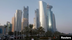 FILE - A man walks on the corniche in Doha, Qatar, June 15, 2017.