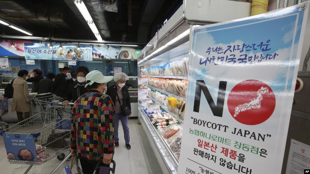 A notice denouncing the Japanese government's decision on releasing treated radioactive Fukushima water hangs at the seafood section of a grocery store in Seoul, South Korea, Friday, April 16, 2021. Japan's government announced Tuesday it would…