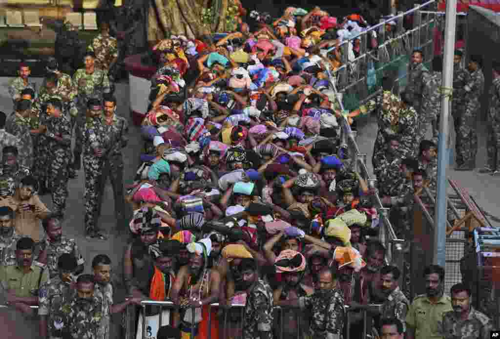 Devotees wait to worship at the Sabarimala temple, one of the world's largest Hindu pilgrimage sites, Kerala state, India. The historic temple which had barred women age 10 to 50 from entering the temple, opened to Hindu pilgrims for a day.