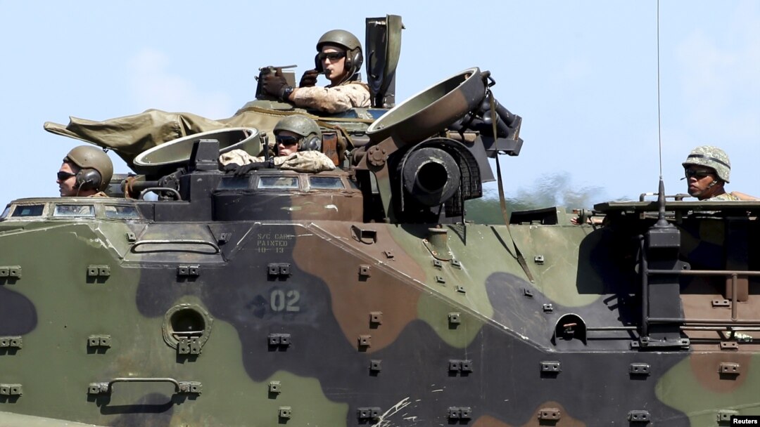 FILE - U.S. Marines from the 3rd Marine Expeditionary Brigade ride on an amphibious assault vehicle during assault exercises with Philippine marine troops in joint drills, Oct. 9, 2015.