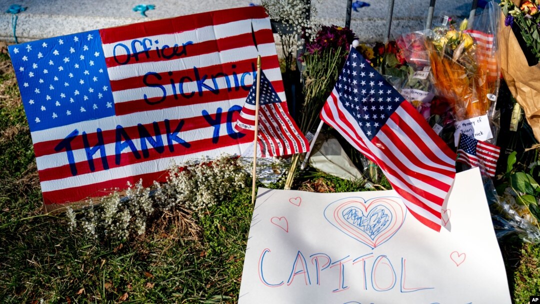 FILE - A memorial for US Capitol Police officer Brian Sicknick is visible near the Capitol Building on Capitol Hill in Washington, Jan. 14, 2021.