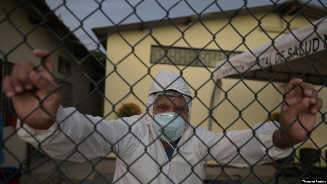 Doctor Bolivar Jalca, who is treating patients experiencing symptoms consistent with COVID-19, poses for a photograph outside Manglaralto Hospital, in Manglaralto, Ecuador, May 2, 2020.