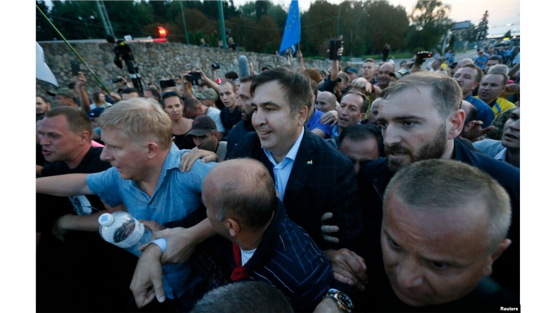 Former Georgian President Mikheil Saakashvili is surrounded by his supporters as he arrives at a checkpoint on the Ukrainian-Polish border in Shehyni, Ukraine, Sept. 10, 2017.