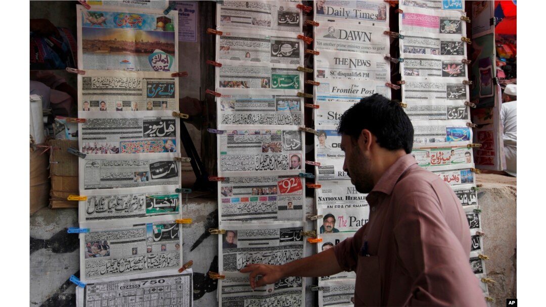 A man reads the morning newspaper displaying the front-page story of the disqualification of Prime Minister Nawaz Sharif by Supreme Court at a stall in Islamabad, July 29, 2017.