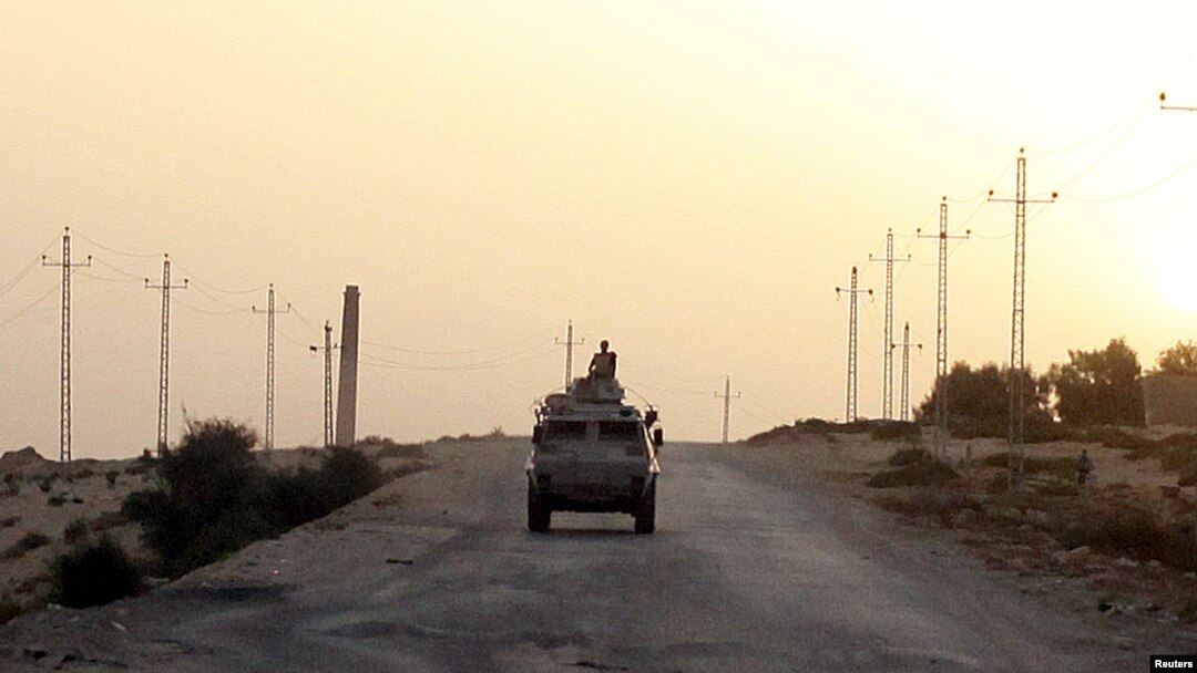 FILE - An Egyptian military vehicle is seen on a highway in northern Sinai, Egypt, May 25, 2015.