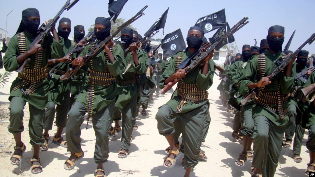 FILE - Al-Shabab fighters are seen marching with their weapons during exercises on the outskirts of Mogadishu, Somalia, Feb. 17, 2011. 