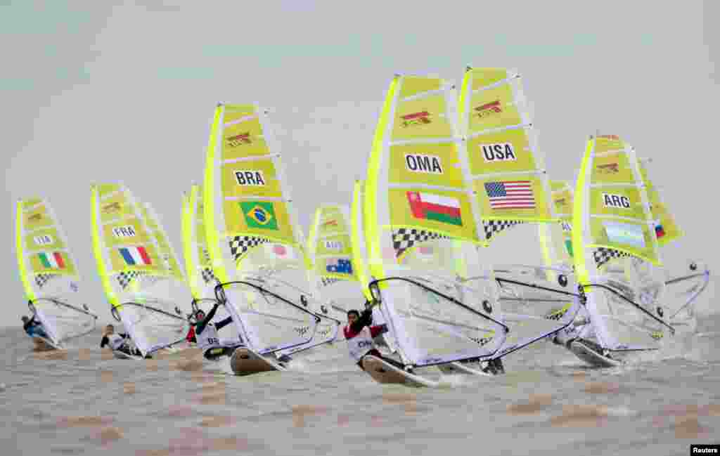 Guilherme Trainini Hony Plentz of Brazil in pursuit of Mohammed Nabil Al Balushi of Oman with Nicolo Renna of Italy, Tom Garandeau of France, Alex Halank of Australia, Manuel Nores of the U.S., Imad Eddine Brighet of Algeria, Belisario Kopp of Argentina, Belisario Kopp of Argentina, Egor Zhilin of Russia and Alex Torres Rinaldelli of Mexico behind in Race 11 of the Sailing Mens Windsurfer Techno 293+ at Club Nautico San Isidro during The Youth Olympic Games, Buenos Aires, Argentina.