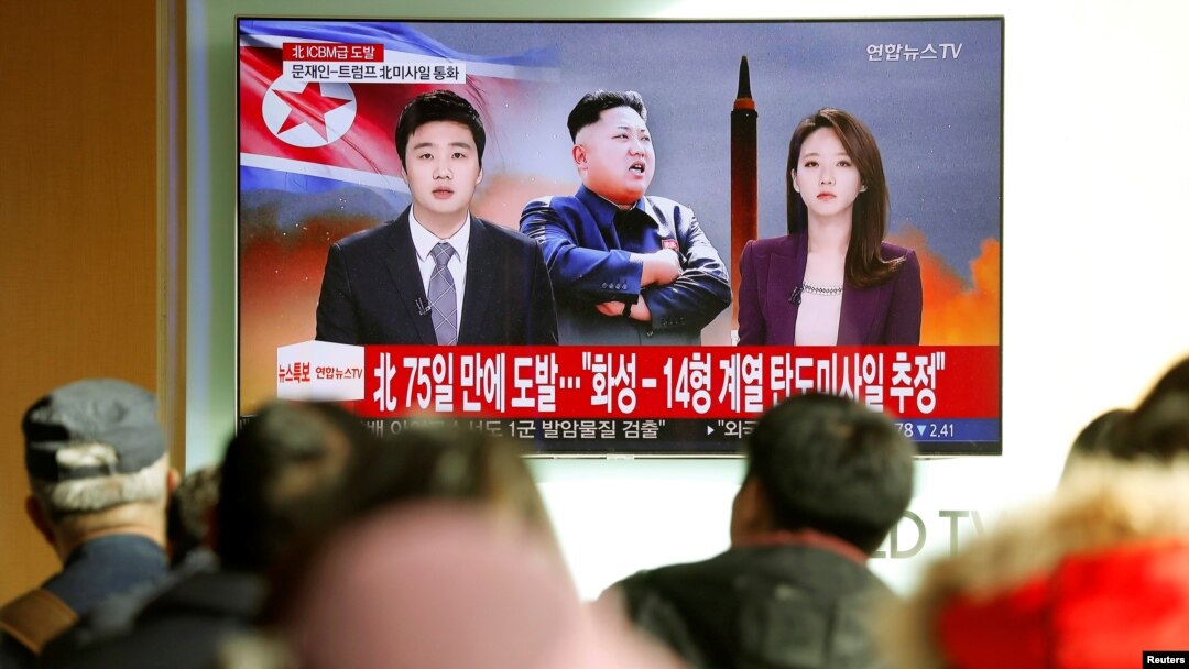 FILE - People watch a TV broadcasting a news report on North Korea's firing of what appeared to be an intercontinental ballistic missile that landed close to Japan, in Seoul, South Korea, Nov. 29, 2017. 