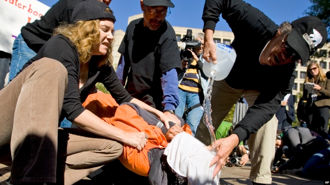 FILE - Protestors demonstrate the use of waterboarding in front of the Justice Department in Washington. 