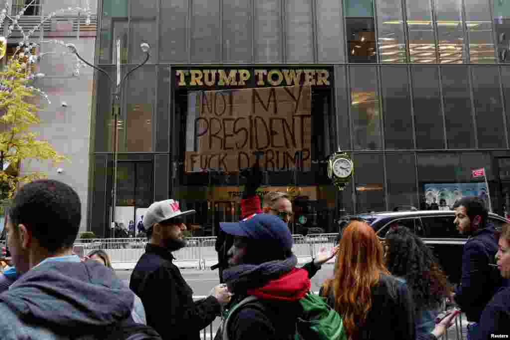 A woman protests outside Trump Tower following President-elect Donald Trump's election victory, in New York City, Nov. 10, 2016. 