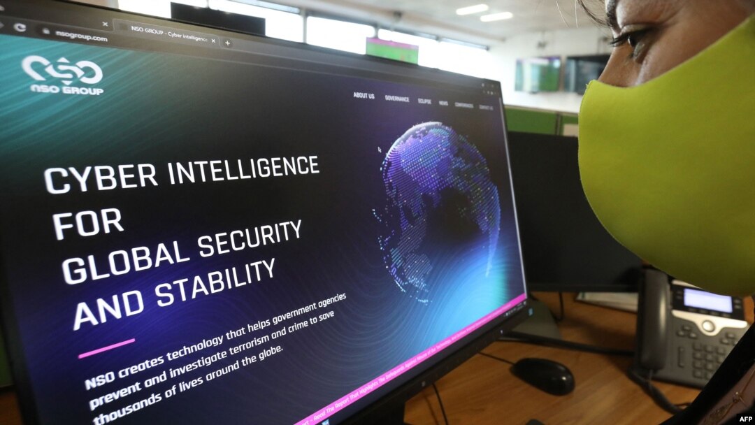 FILE - A woman checks the website of Israel-made Pegasus spyware at an office in the Cypriot capital Nicosia on July 21, 2021. Israel-made Pegasus spyware was used to monitor activists, journalists and politicians around the world.