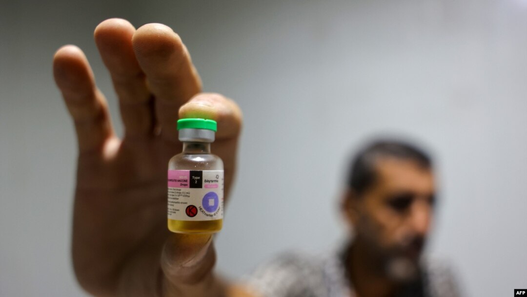 A worker shows a vial containing a polio vaccine provided with support from UNICEF to the Gaza Strip through the Karm Abu Salem crossing, also known as Kerem Shalom, at a depot belonging to Gaza's Health Ministry, Aug. 25, 2024.
