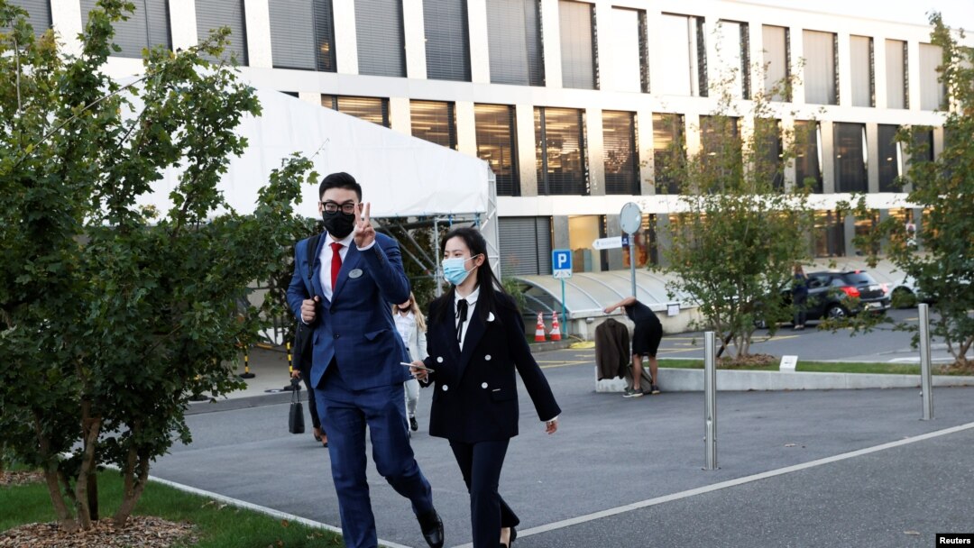 Students walk out of the Ecole Hoteliere de Lausanne after its students were put under quarantine in Lausanne, Switzerland, Sept. 23, 2020.
