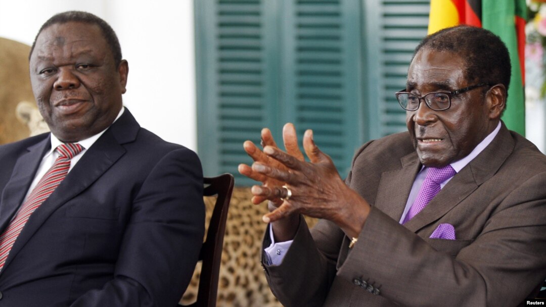 Zimbabwean President Robert Mugabe (R) and Prime Minister Morgan Tsvangirai announce the resolution of longstading disputes over a draft constitution at a press conference in Harare, January 17, 2013.