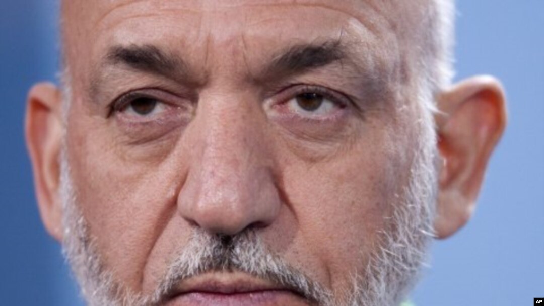 Afghan President Hamid Karzai during a news conference with German Chancellor Angela Merkel after a meeting at the chancellery in Berlin, December 6, 2011.