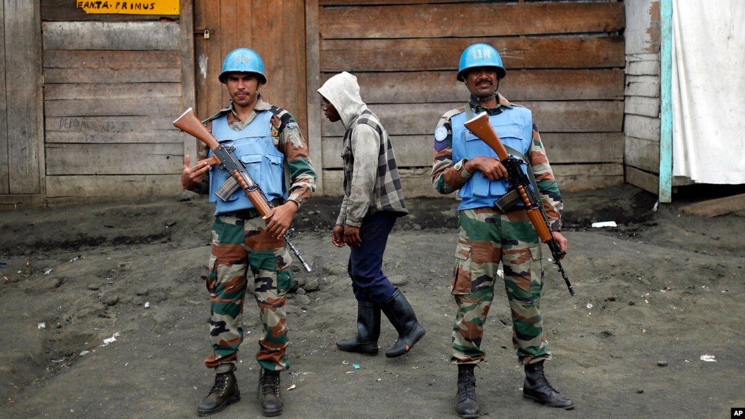 FILE - Two MONUSCO UN soldiers stand guard in Goma's port, eastern Congo.