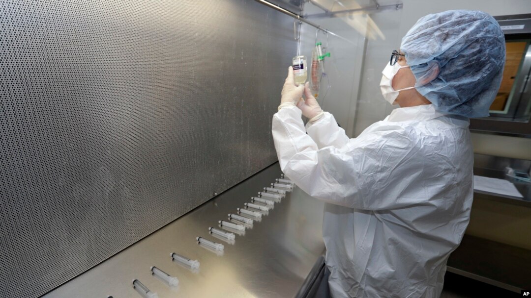 FILE - In this Jan. 8, 2018 photo, certified pharmacy technician Peggy Gillespie compounds antibiotics to fill into syringes for use as an I.V. push at ProMedica Toledo Hospital in Toledo, Ohio. 