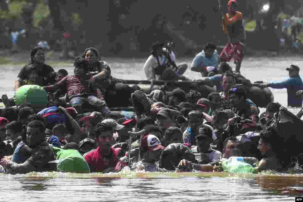 Migrants cross the Suchiate River from Tecun Uman in Guatemala to Ciudad Hidalgo in Mexico, after a security fence on the international bridge was reinforced,