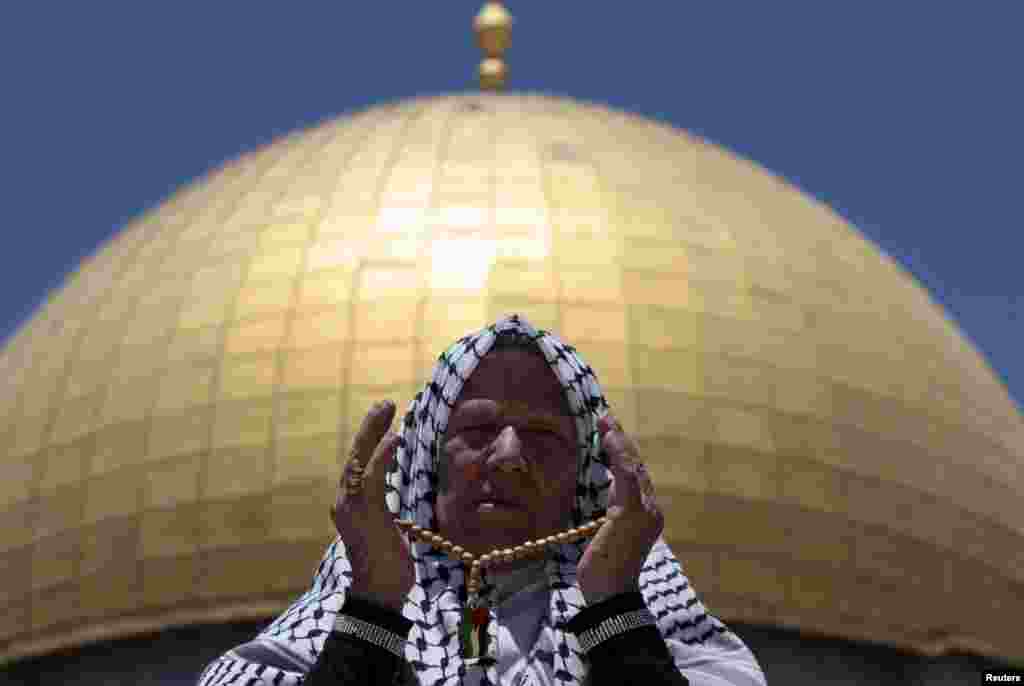 A Palestinian worshiper prays in front of the Dome of the Rock on the compound known to Muslims as Noble Sanctuary and to Jews as Temple Mount in Jerusalem's Old City, during the holy month of Ramadan.