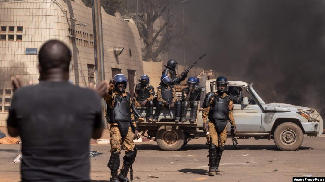A protestor faces security forces during a demonstration in Ouagadougo, Burkina Faso, Nov. 27, 2021.