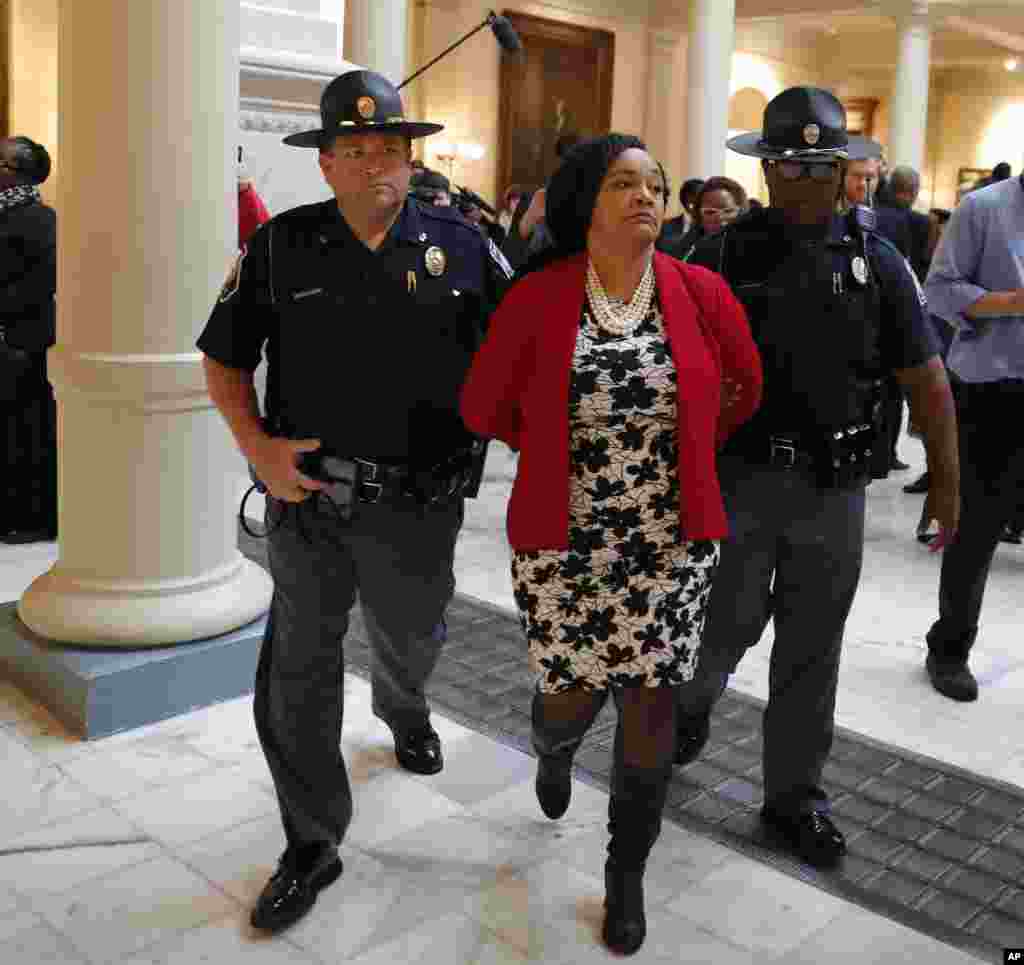 Sen. Nikema Williams (D-Atlanta) is arrested by capitol police during a protest over election ballot counts in the rotunda of the state capitol building, Nov. 13, 2018, in Atlanta, Georgia.