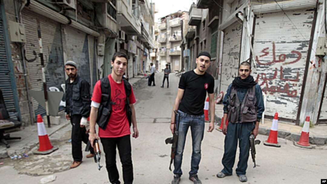 Syrian rebels stand in the Khalidiya district of the central Syrian city of Homs, May 3, 2012. 