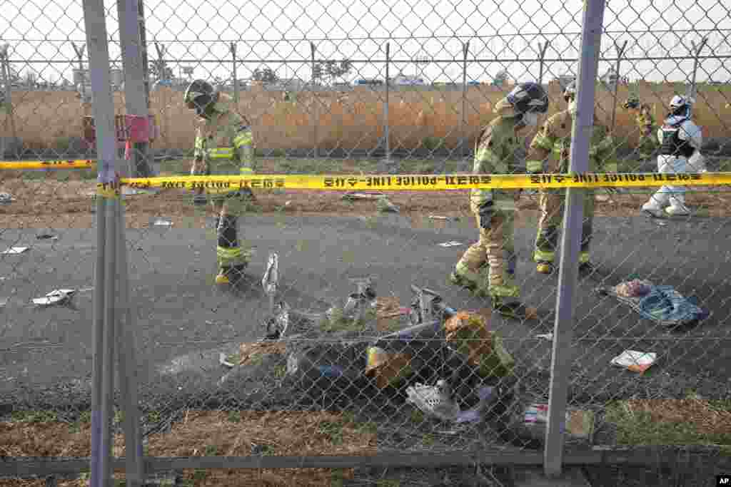 Rescue team members work near the wreckage of the plane outside of Muan International Airport, Dec. 29, 2024.
